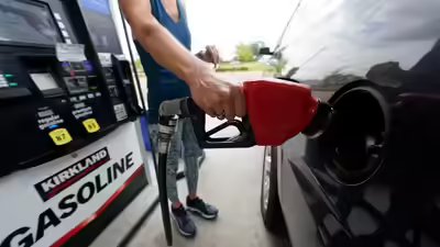 A customer readies to pump gas ap photo.jpg