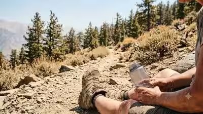 A lone hiker suffering from heat exhaustion on a steep forest trail in the adirondack mountains.jpg