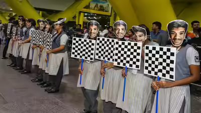 Chennai school students hold chess board designed placards to welcome candidate.jpg