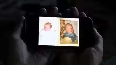 Jeremy morrison holding the baby photos he believes show the switch.jpg