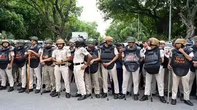 Police personnel stand guard near.jpg