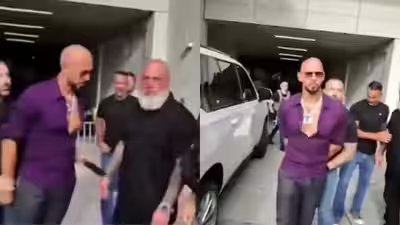 Video shows andrew tate trying to hand mobile to his bodyguard.jpg