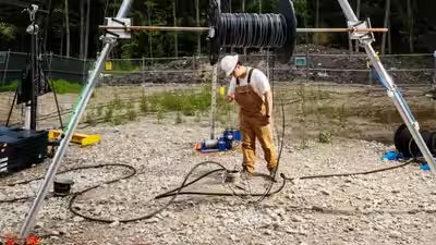 A worker prepares the well on a boston area horse farm to lower edens electrode.jpg