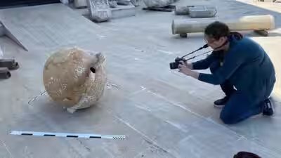 An archaeological amphora being photographed.jpg
